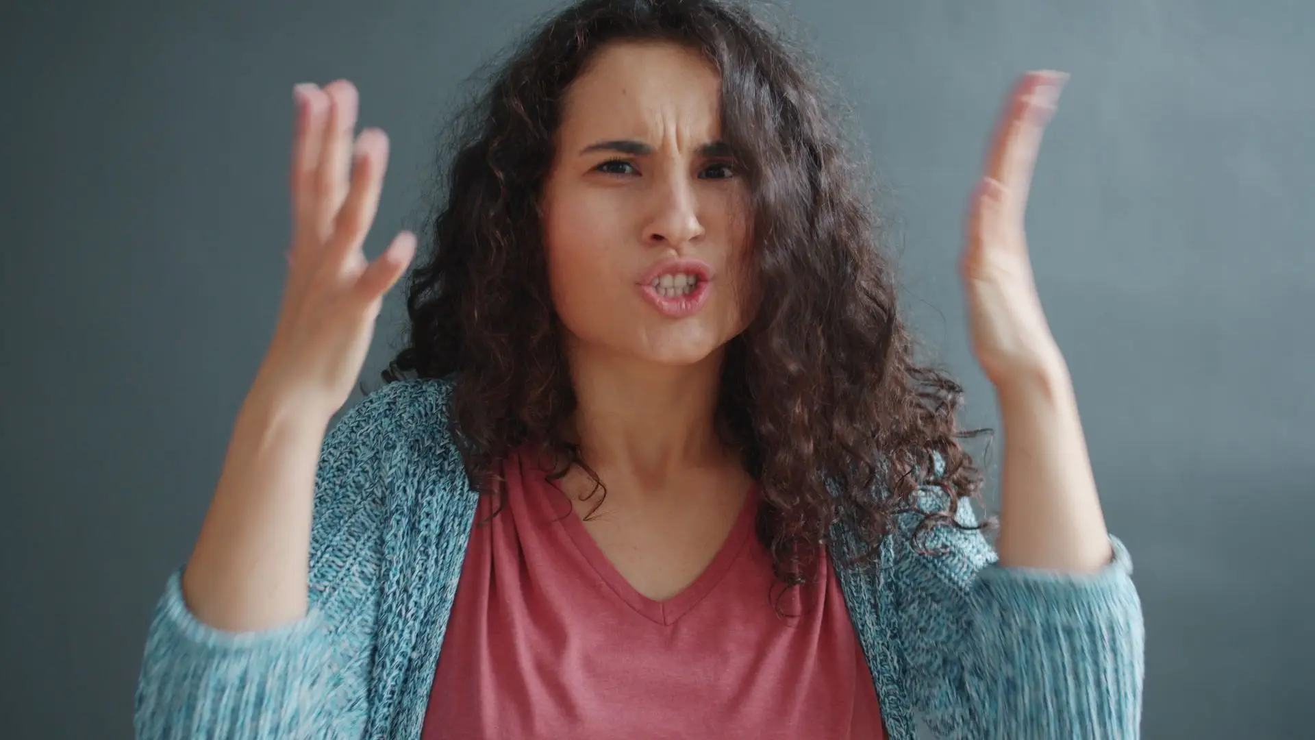 una mujer muestra ambas manos expresando su frustración